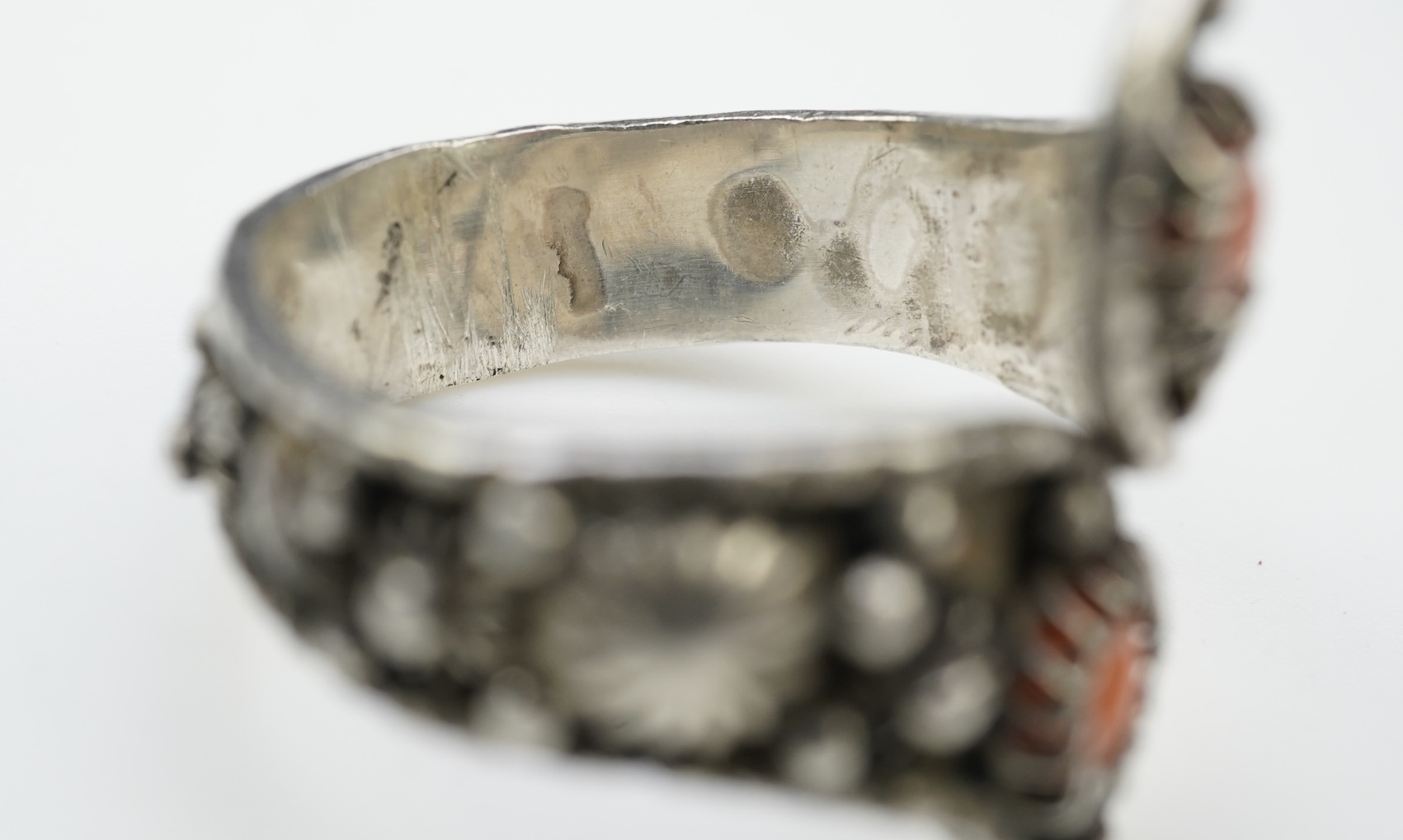 A collection of silver jewellery including a Zuni bangle